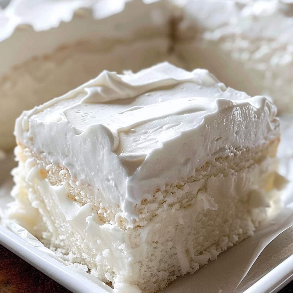 Savor the decadent “Divine Delight: Heavenly White Snack Cake,” a light, fluffy cake with a rich, buttery taste that perfectly captures the understated beauty of a traditional white cake.